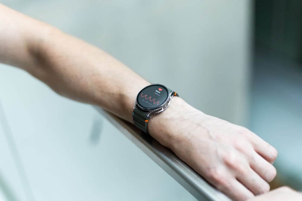 Close-up of smart watch health tracker with the heart rate shown on the screen.
