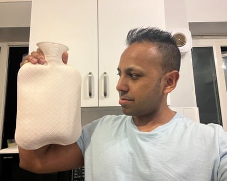 Ravi Meah holding a white hot-water bottle.