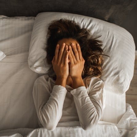 Woman struggling to sleep in a heatwave