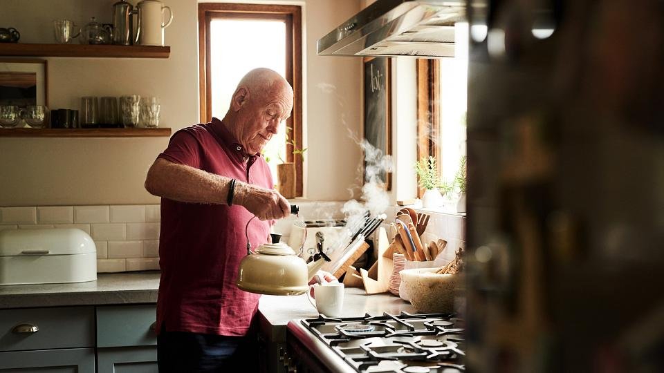 Man pouring himself a cup of tea