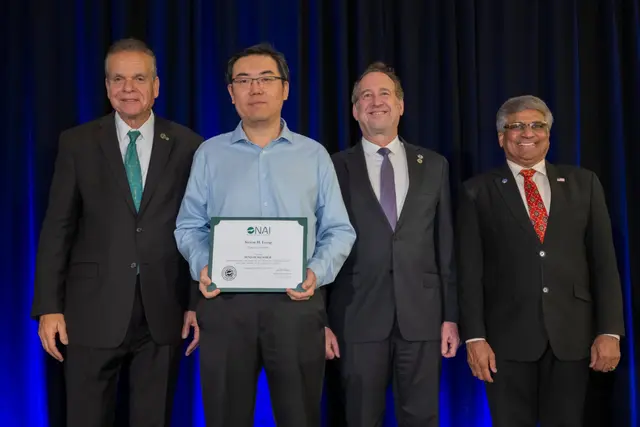 Emory University professor Steven Liang receiving an award