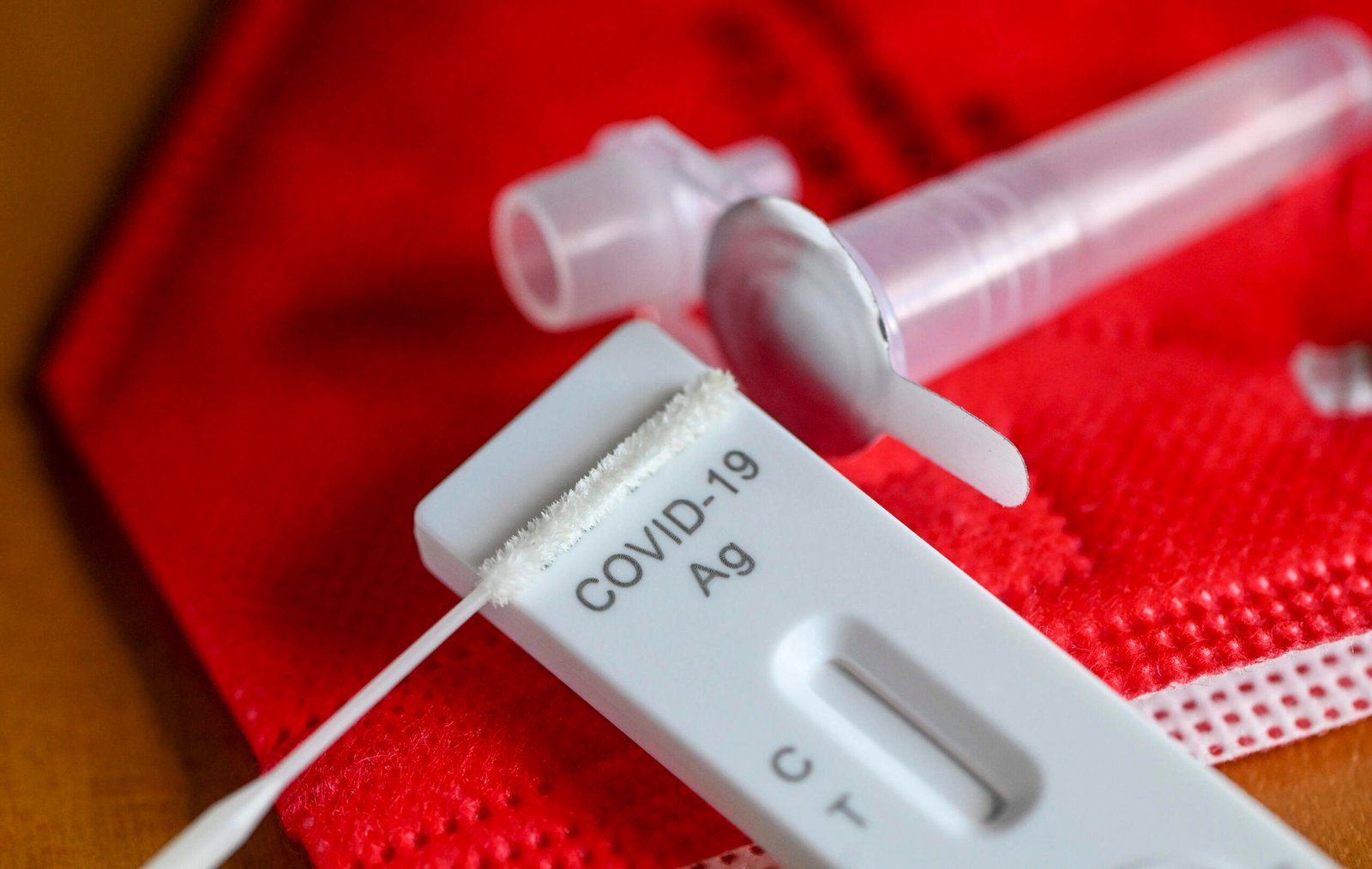 An antigen test to detect COVID-19 for self-testing is on a red mask. (Jens Kalaene/picture alliance via Getty Images)
