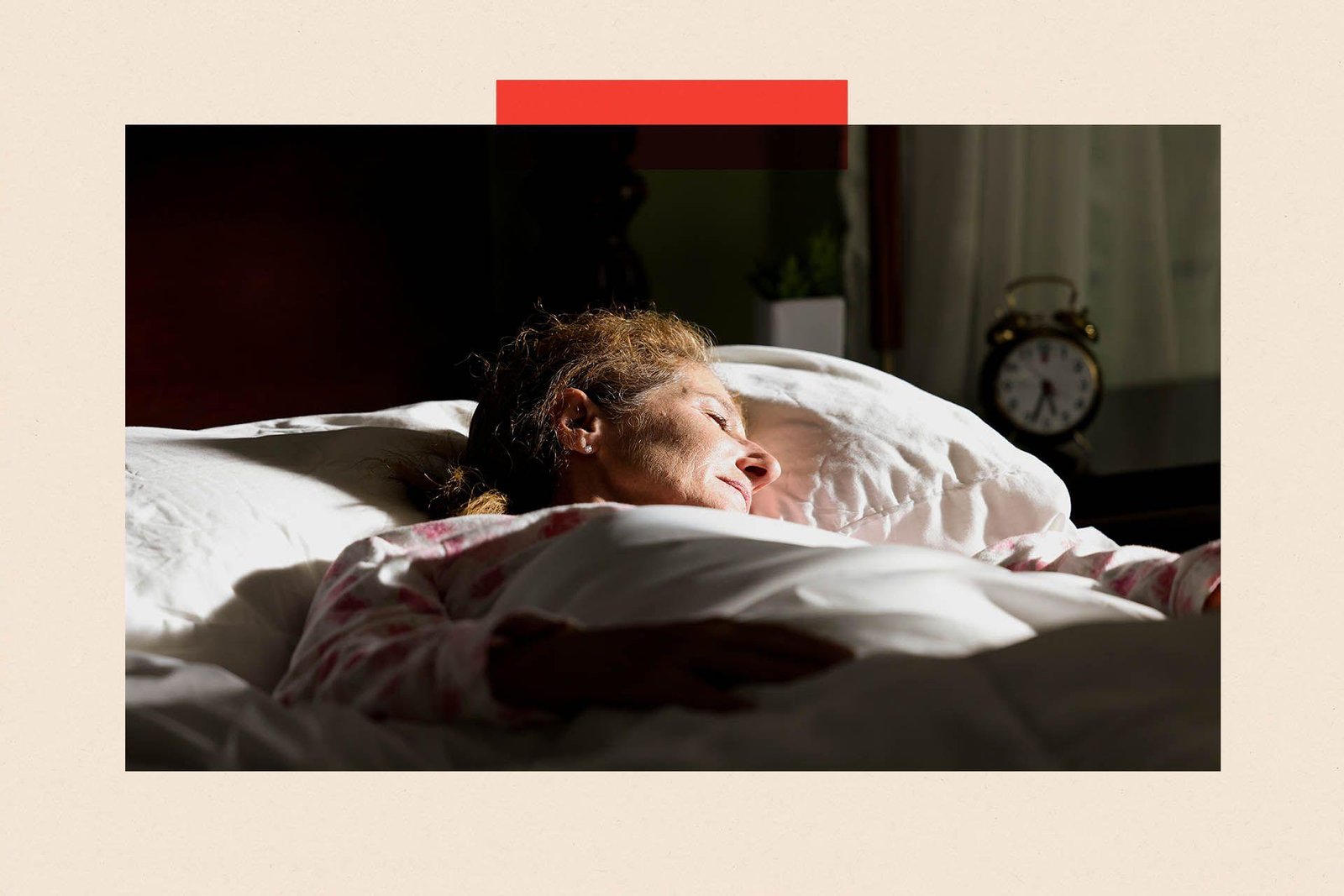 A woman trying to sleep as the sun shines on her bed