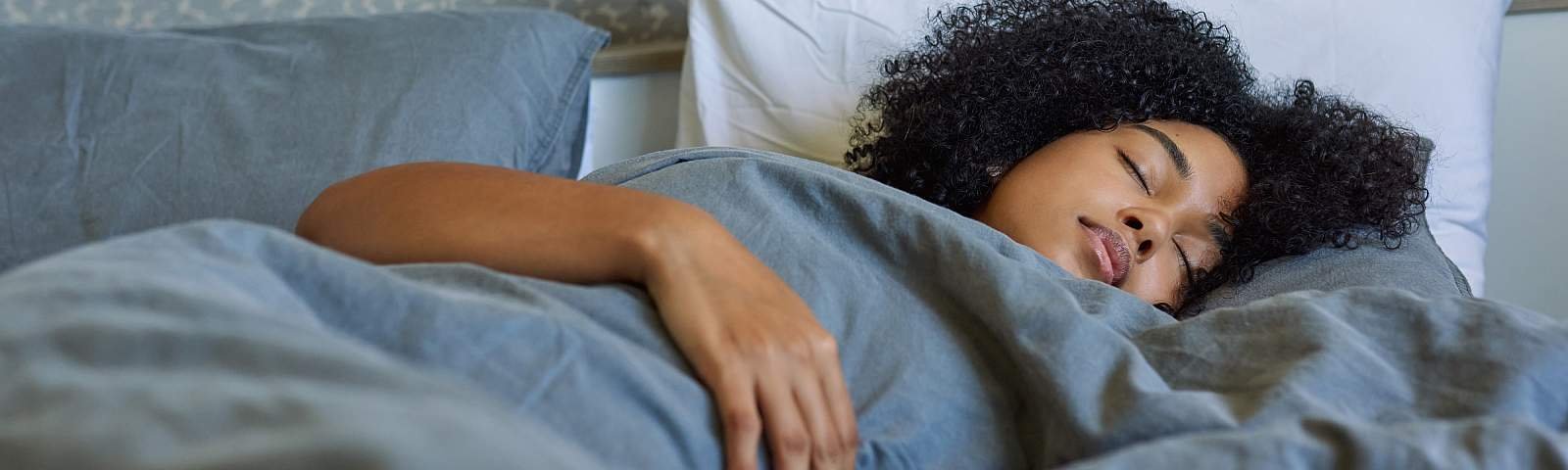 Woman sleeping in her bed