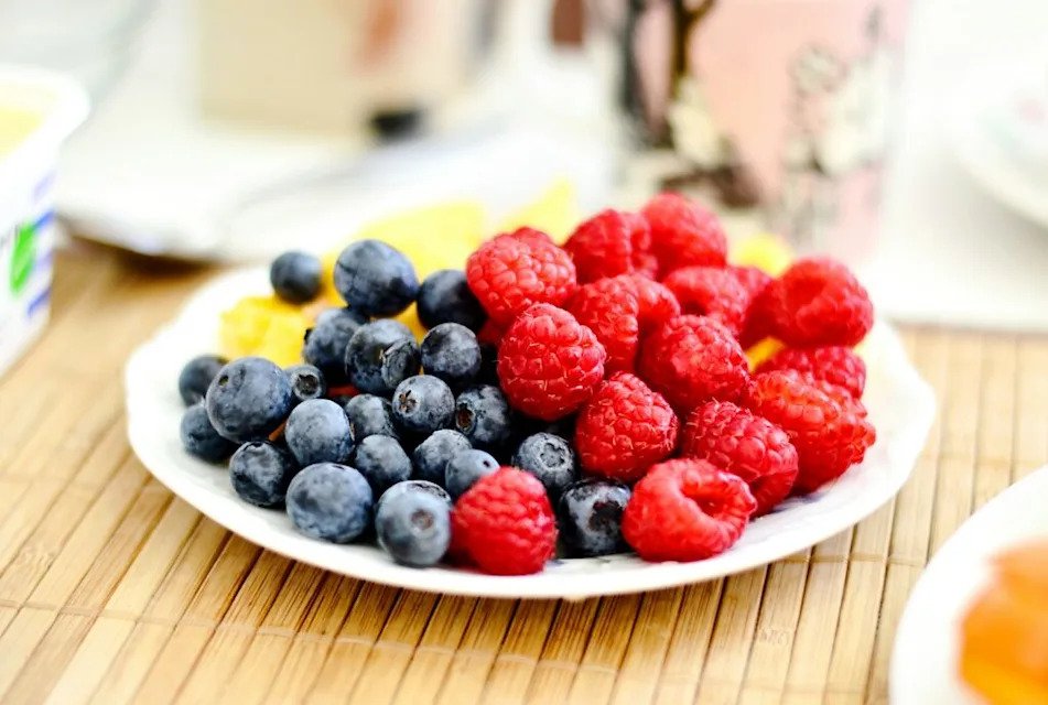 strawberries and blue berries on plate