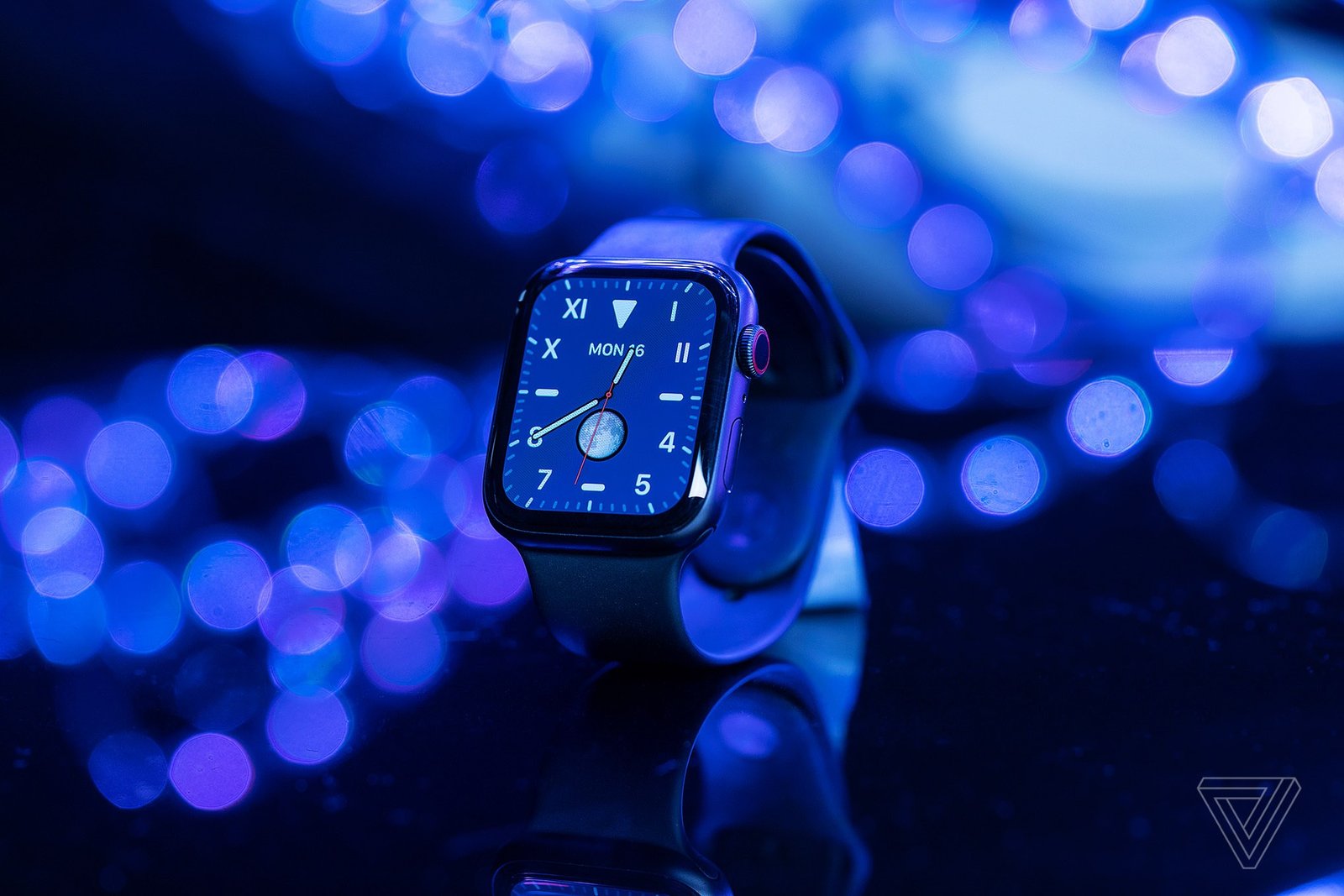 The apple watch series 5 on a reflective background