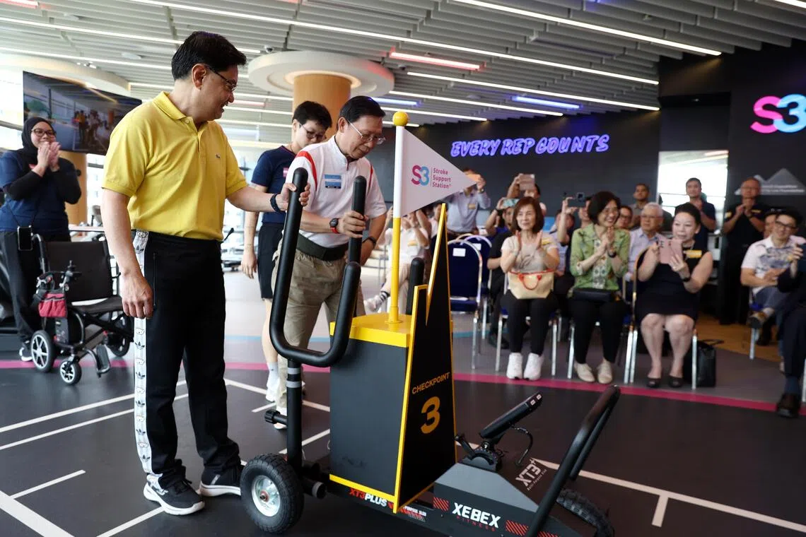 Guest of honour Heng Swee Keat (left), pushing a prowler sled with stroke survivor John Seah, 66, as part of the relay to officially open the stroke-focused adaptive gym S3 Summit.