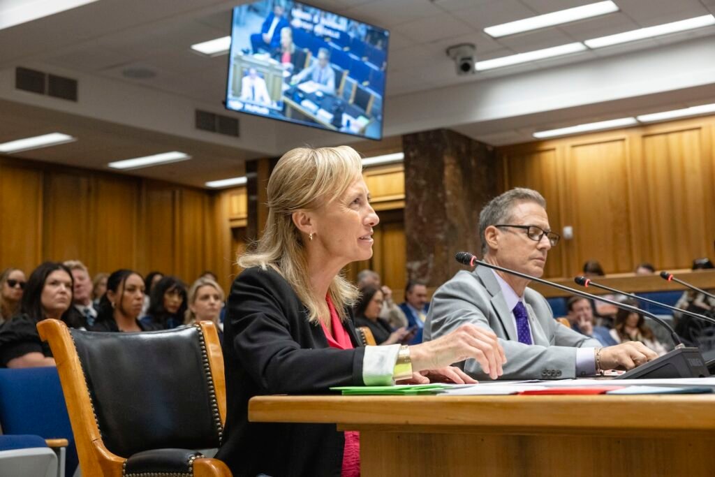 Dr. Evelyn Griffin, Louisiana’s surgeon general, speaks into a microphone seated a table in a legislative committee room.