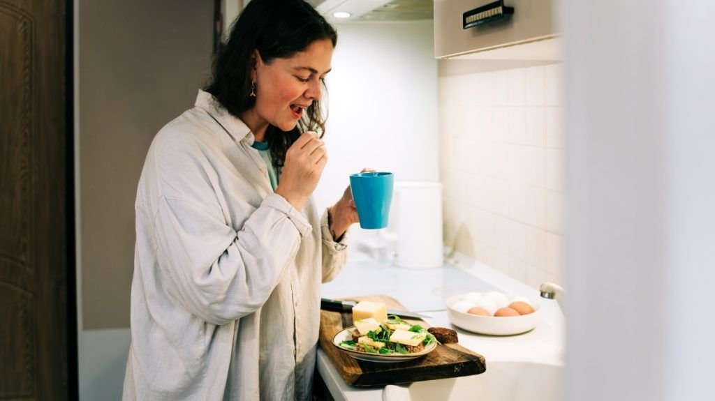 A person eating cheese and eggs.