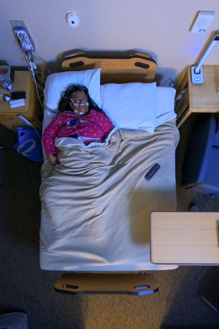 Overhead view of a patient sleeping on her back deeper into the night.