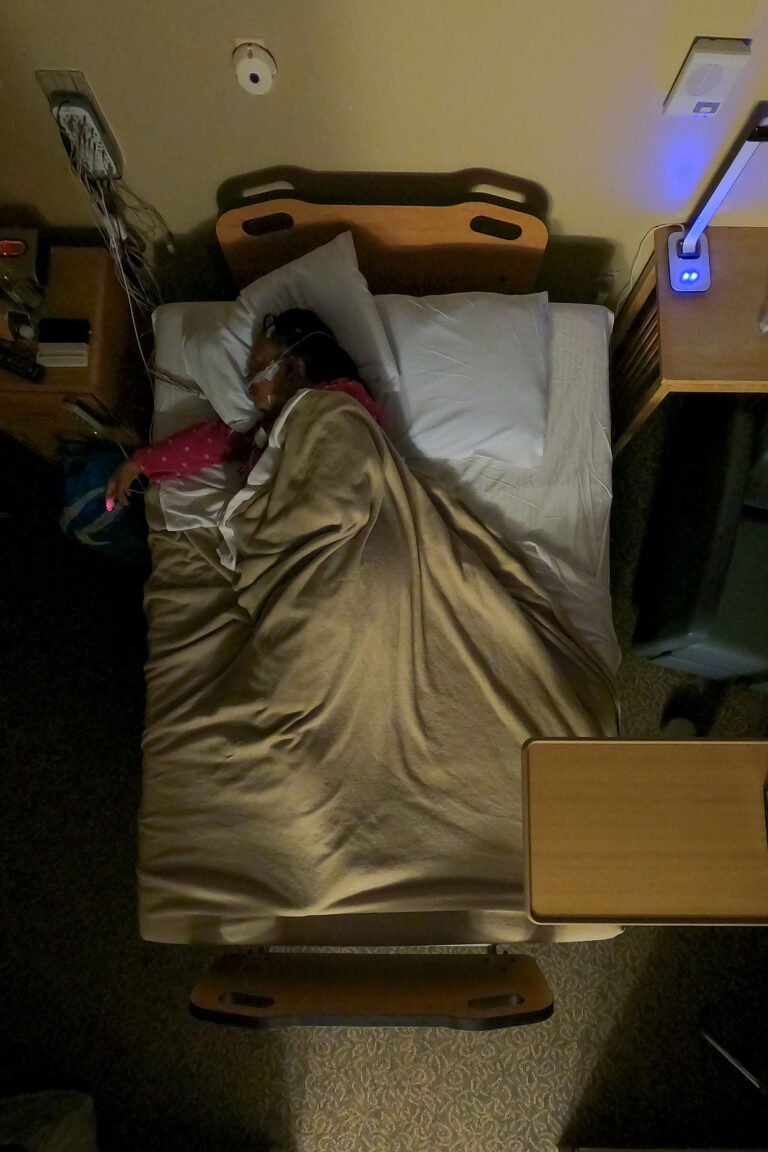 Overhead view of a patient curled on her side, having shifted during sleep.