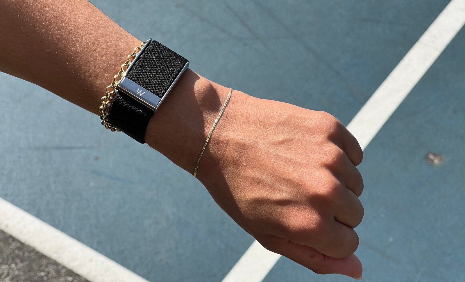 A hand with the Whoop 5.0 on the wrist.