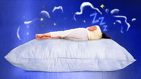 BBC Serenity Strull/ Getty Images A woman asleep on a giant pillow, surrounded by a blue night sky (Credit: BBC/ Serenity Strull/ Getty Images)