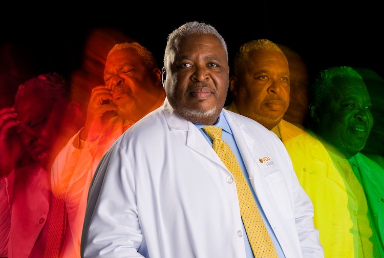 Dr. Wally Smith in his white coat with different versions of himself in the background