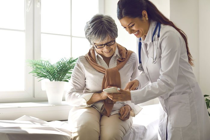 Doctor using a digital wearable device to check a child’s health in a clinical setting.