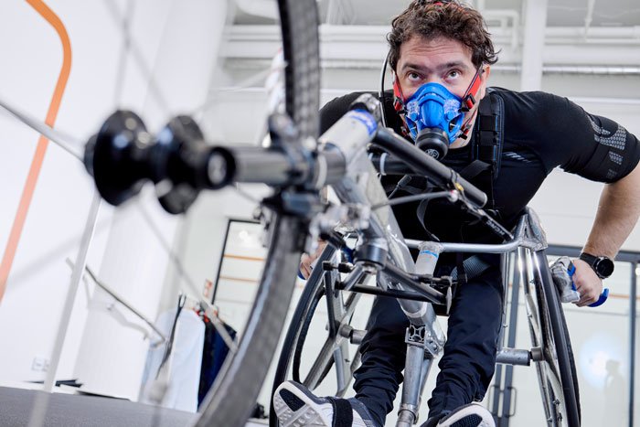 Man on a bicycle while using a wearable device to track fitness and performance.