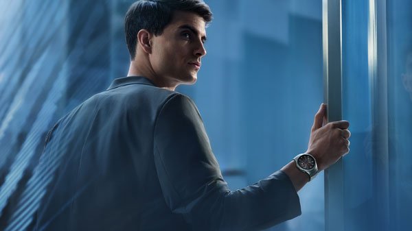 Business professional using a smartwatch to track health data in an office setting.