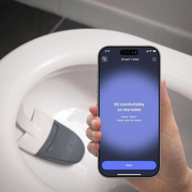 The Vivoo smart toilet on a white toilet with a hand holding the phone app.