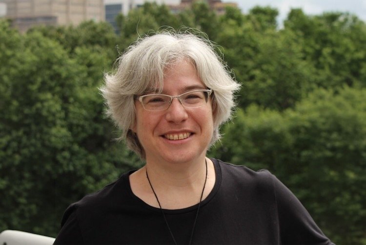 Dr. Etz wearing a black t-shirt standing outside.