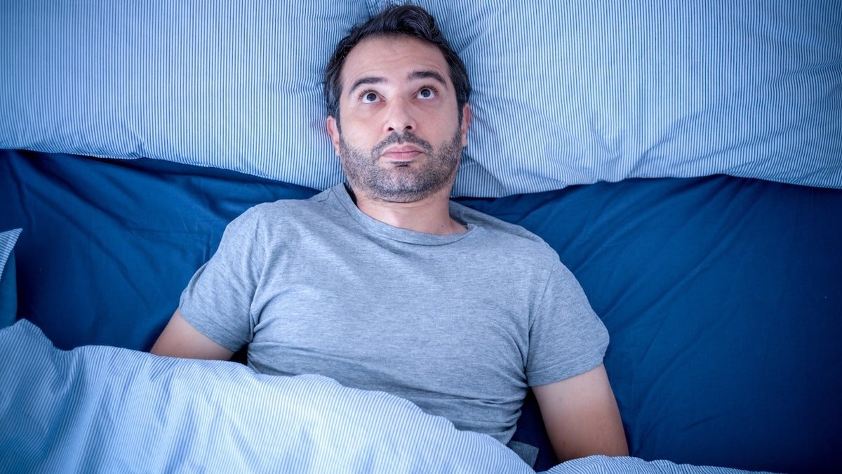 Man awake at night can't sleep