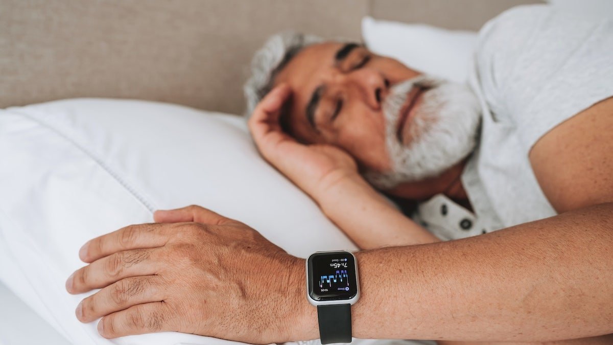 Man sleeping with smartwatch